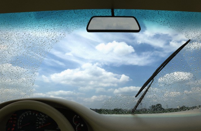Wipers cleaning windscreen --- Image by © Volker Moehrke/Corbis