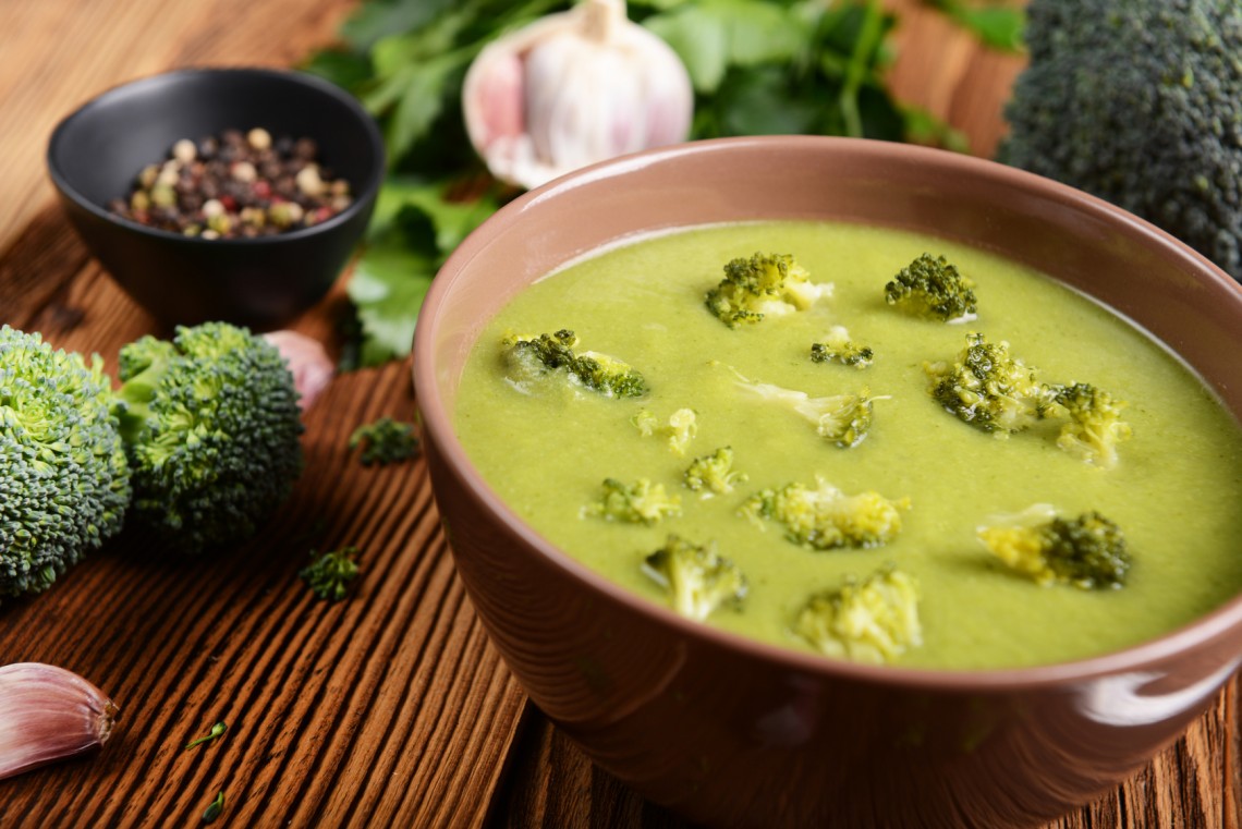 Tasty broccoli soup on wooden background