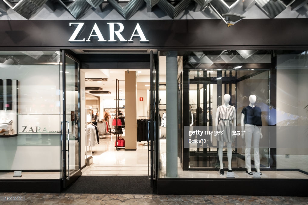 Udine, Italy - April 11, 2015: Illuminated sign and entrance of Zara Fashion Store in city of Udine, Friuli Venezia Giulia, North east of Italy