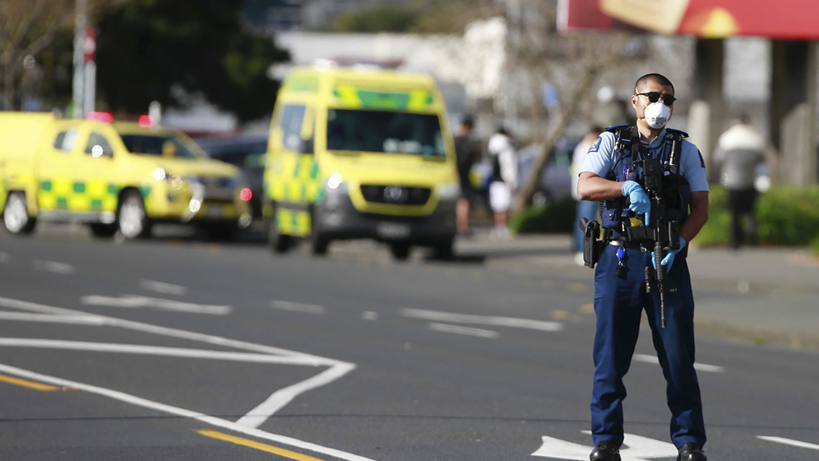 A police officer stands outside an Auckland supermarket, Friday, Sept. 3, 2021. New Zealand authorities said Friday they shot and killed a violent extremist after he entered a supermarket and stabbed and injured several shoppers. Prime Minister Jacinda Ardern described the incident as a terror attack. (Alex Burton/New Zealand Herald via AP)