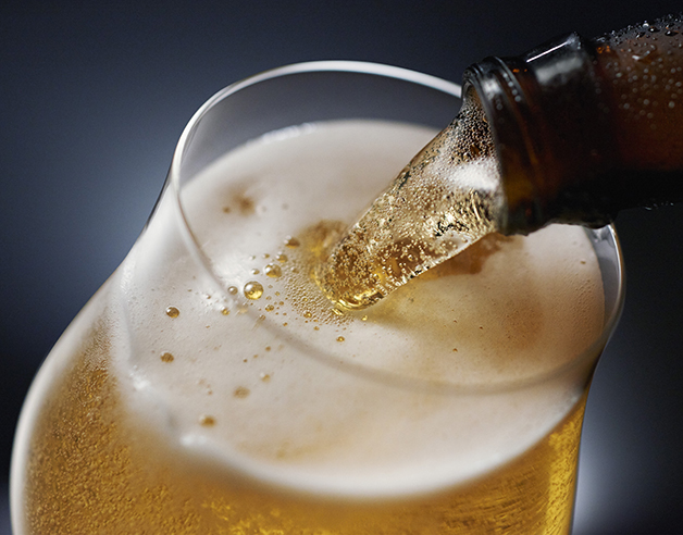 Beer being poured against a dark background